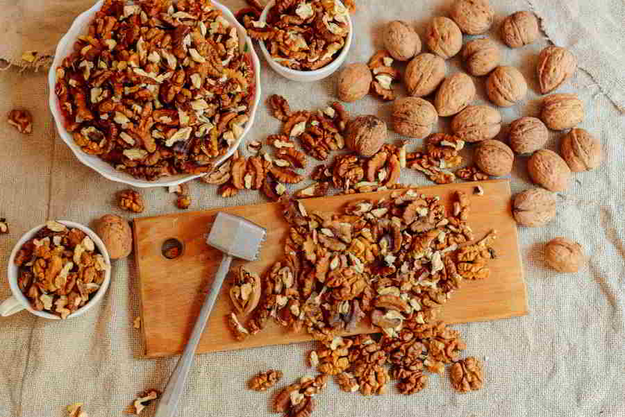 Assortment of nuts Bowl of walnuts on wooden texture