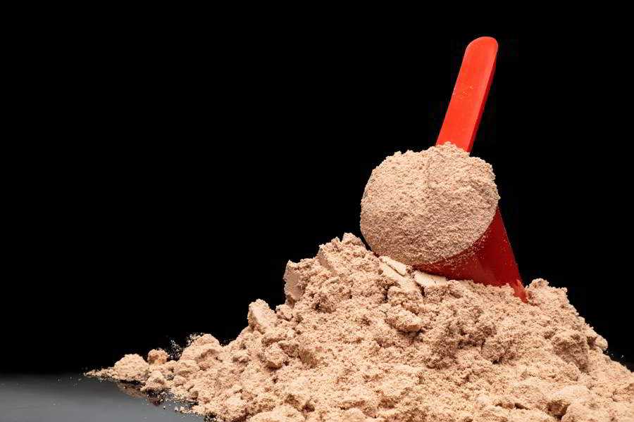 Close-up Whey Protein Powder in measuring scoop
