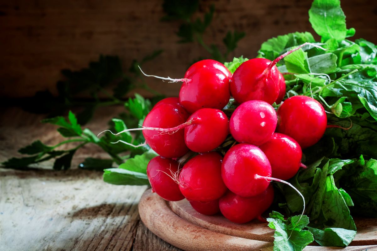 Bunch of red radishes on a cutting board