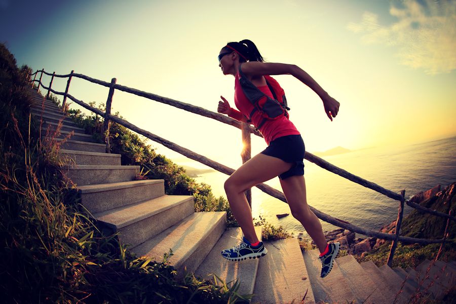 Fitness woman running up stairs
