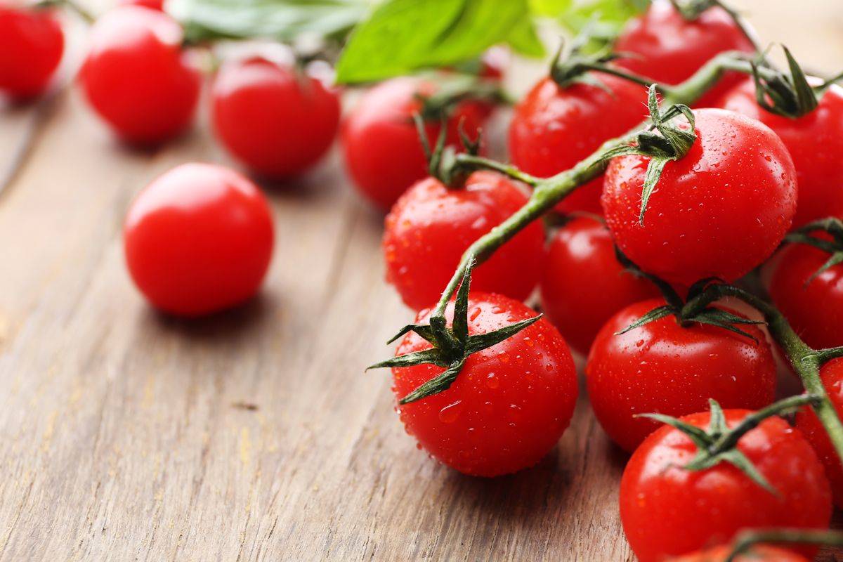 Fresh cherry tomatoes on old wooden table