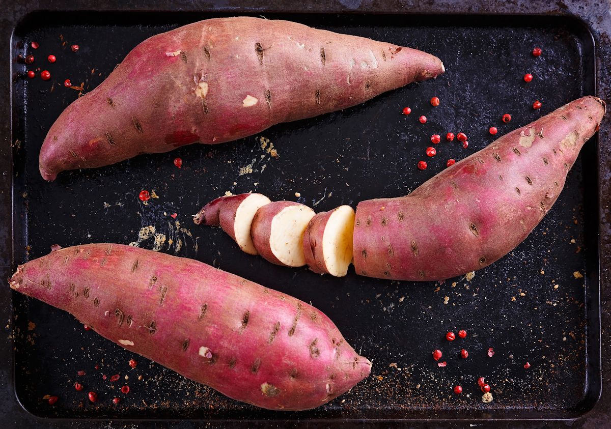 Red Sweet potato over rustic metal tray