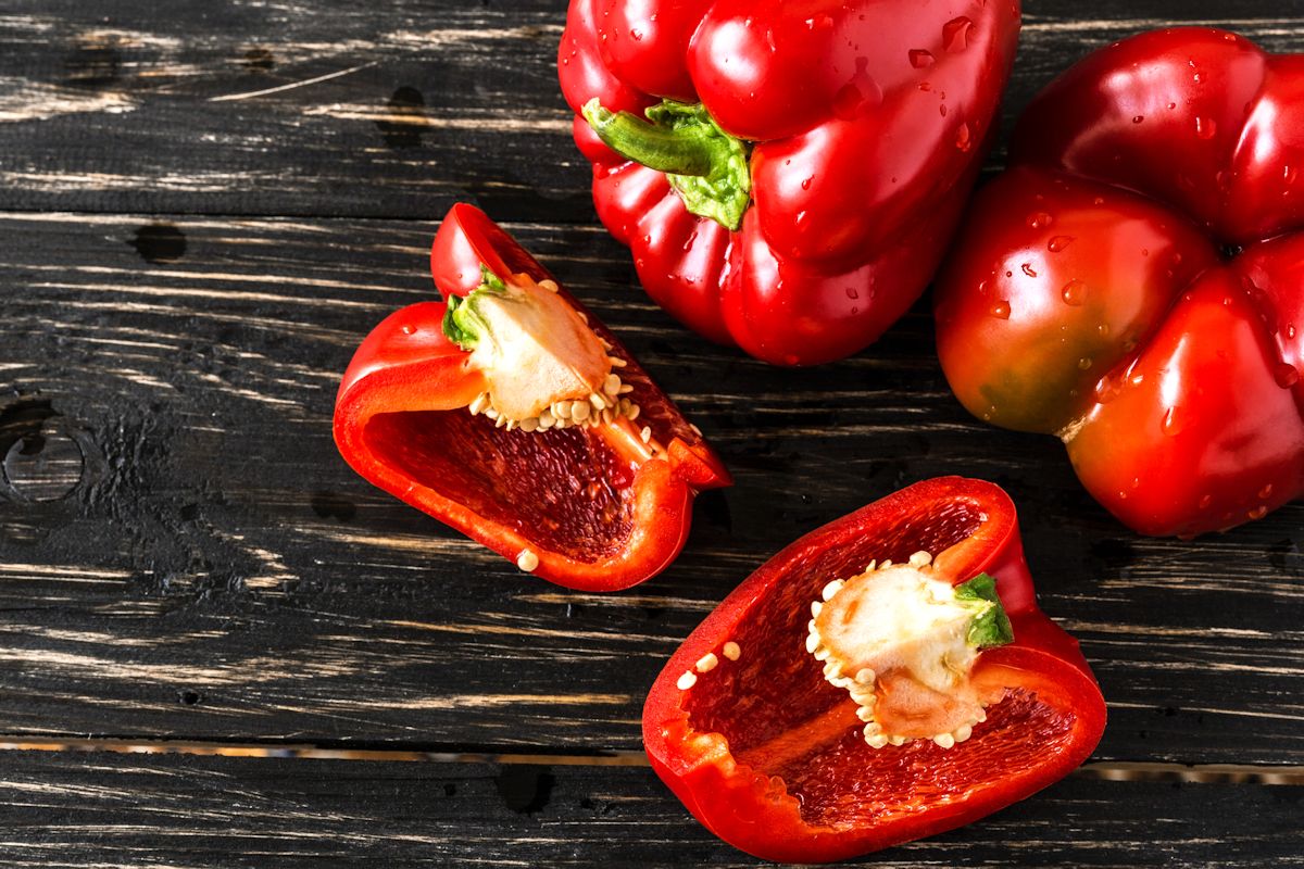 Red bell pepper on wooden background harvest