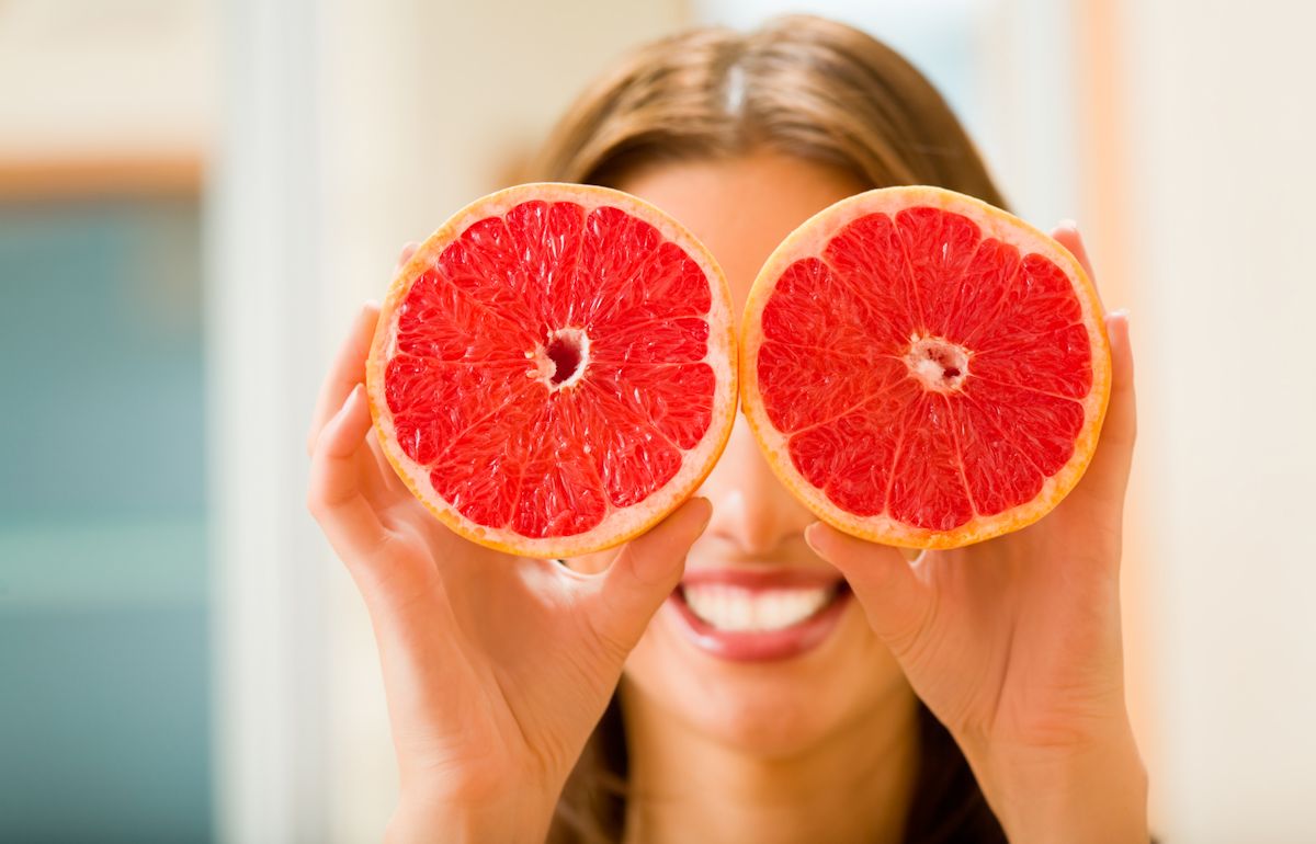 Young woman with grapefruit at home